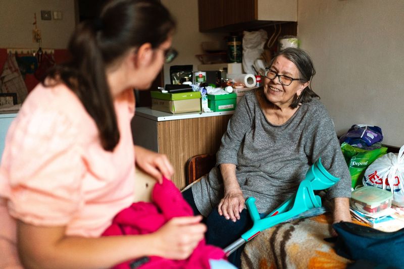 An aide helping a client walk safely