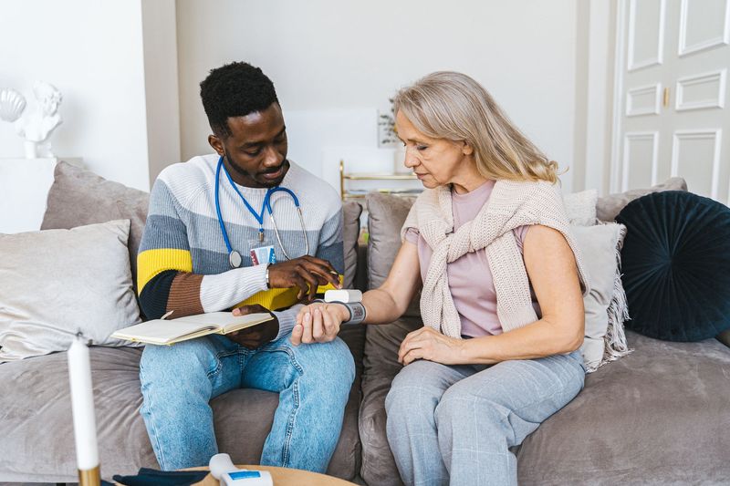A nurse talking with a client at home