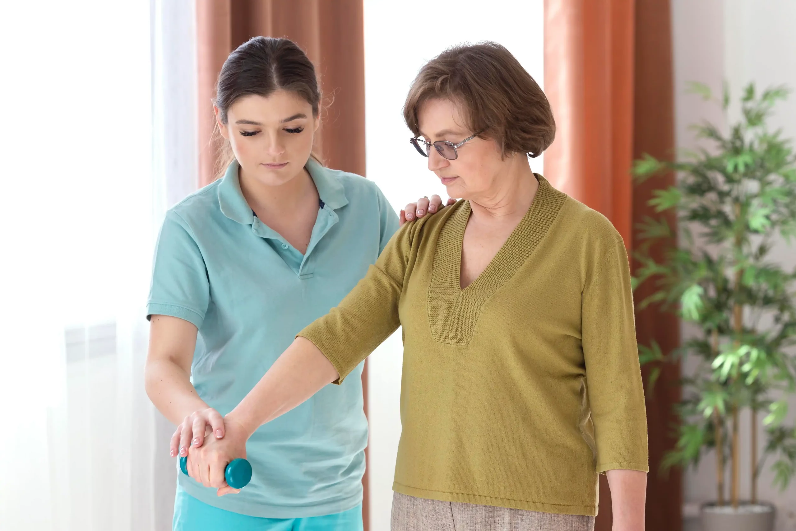 An older woman with a walker receives help from a younger woman, showcasing a moment of support and care.
